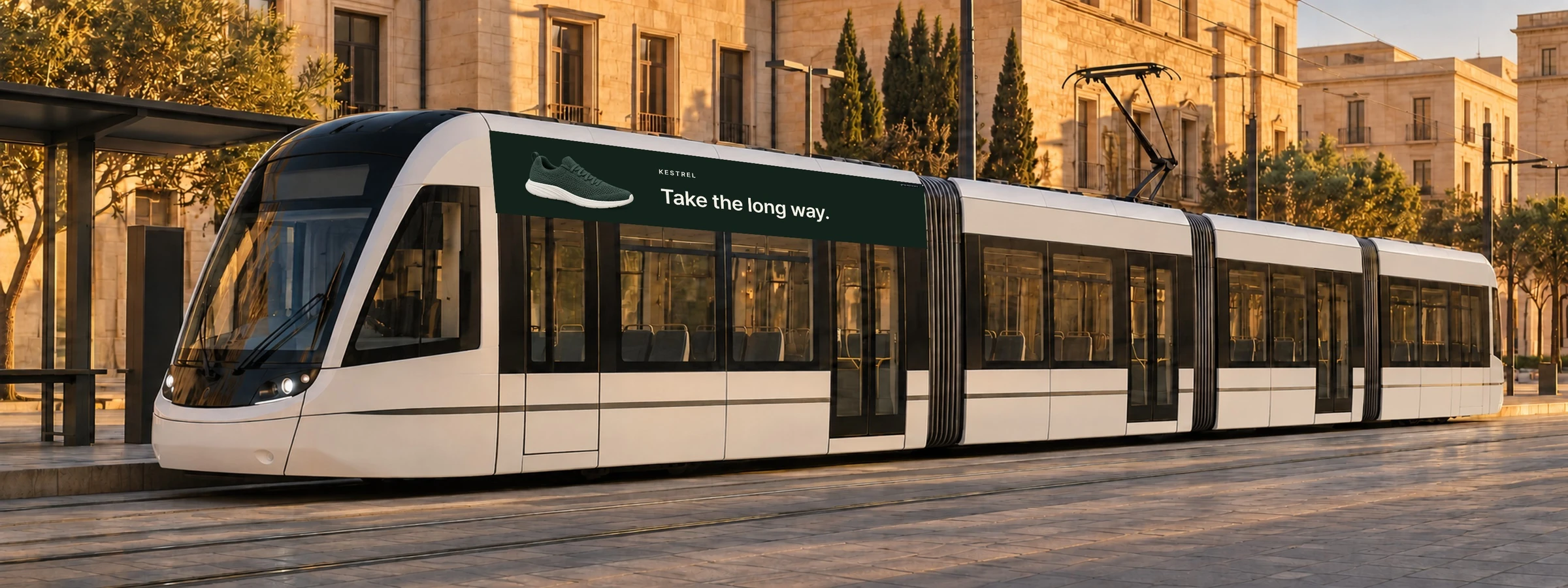 An AI-made mockup: the Kestrel sample poster in the 5:1 cove above a tram’s windows, in low sun.